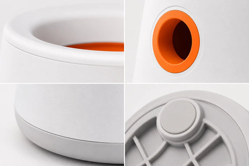 White plastic object with orange interior and gray accents close-up